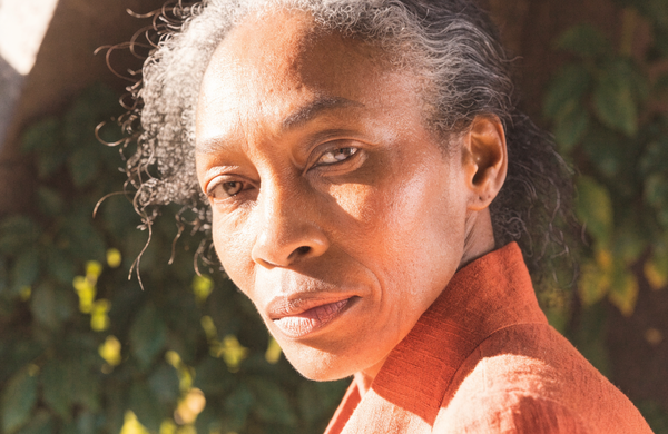 A portrait in late-afternoon light, skin and lines left unretouched.