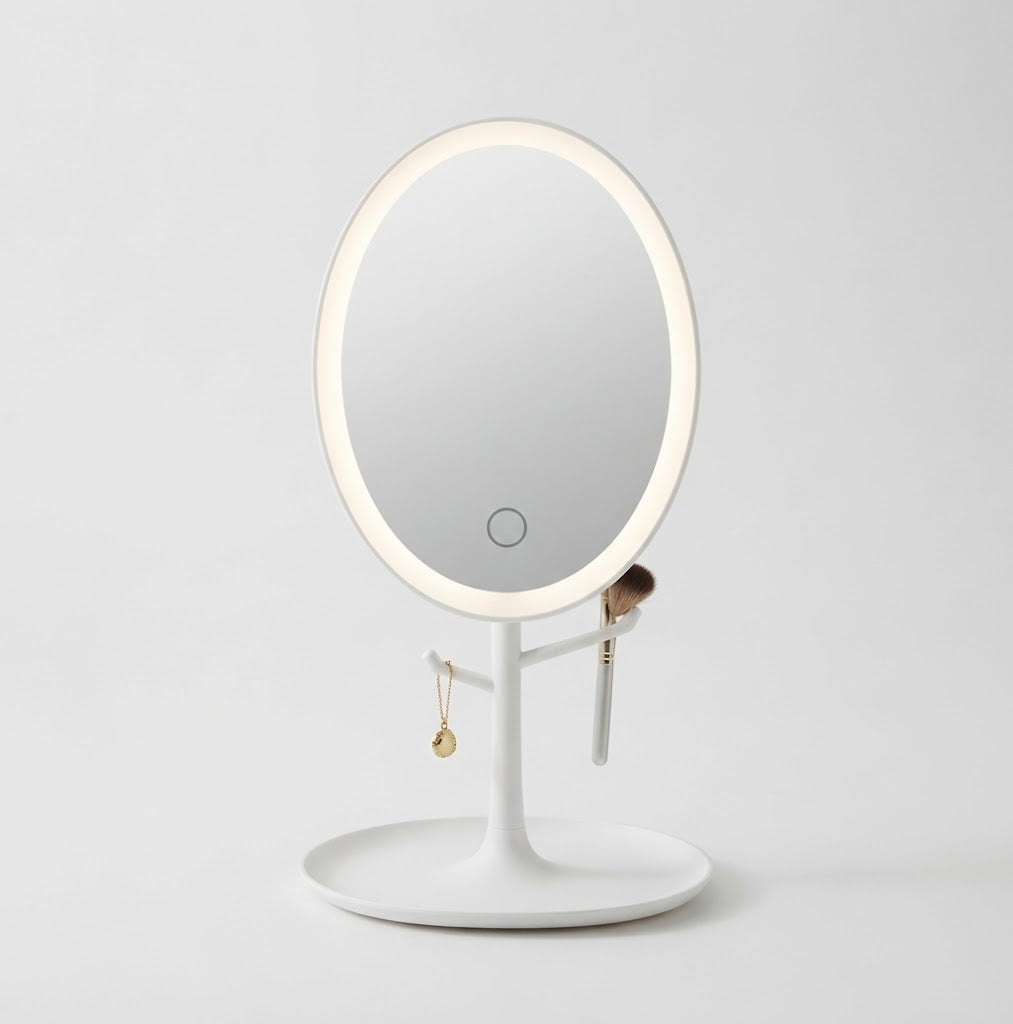 White oval LED makeup mirror with a tray base