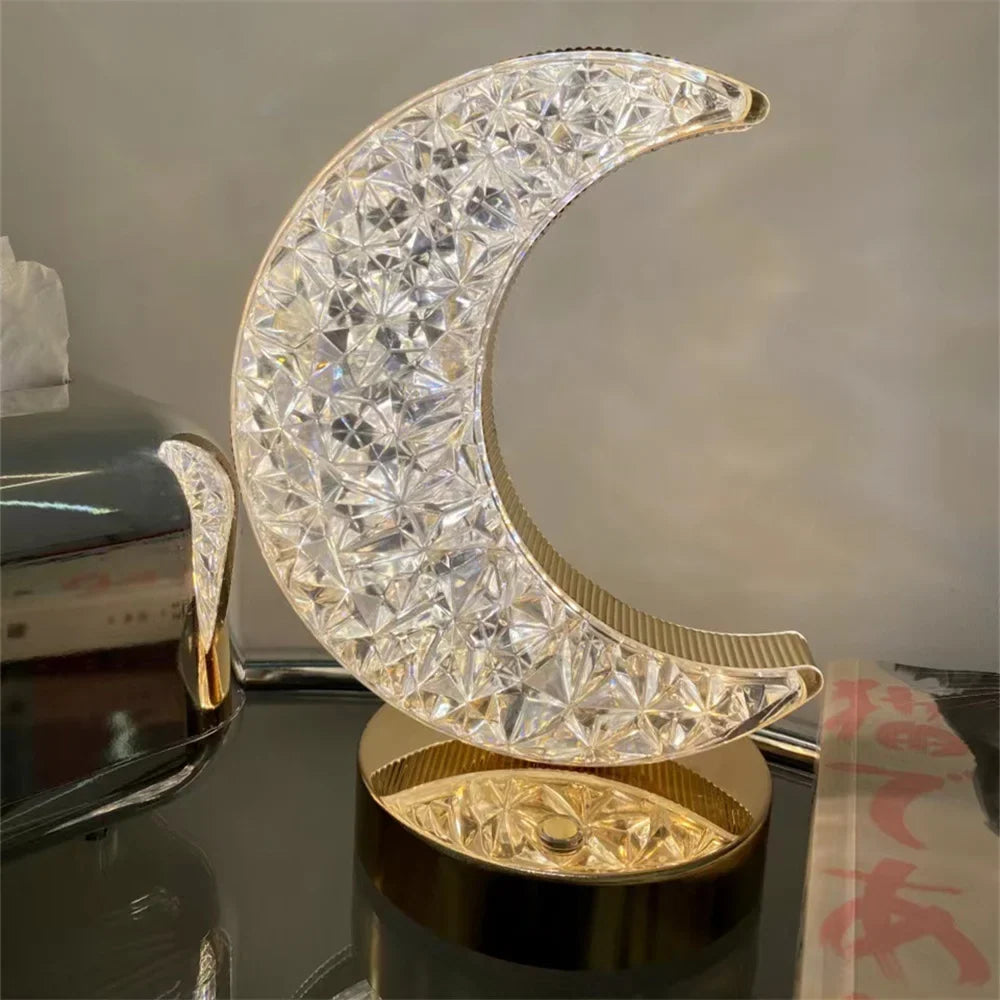Crystal moon LED table lamp with a gold base, lit