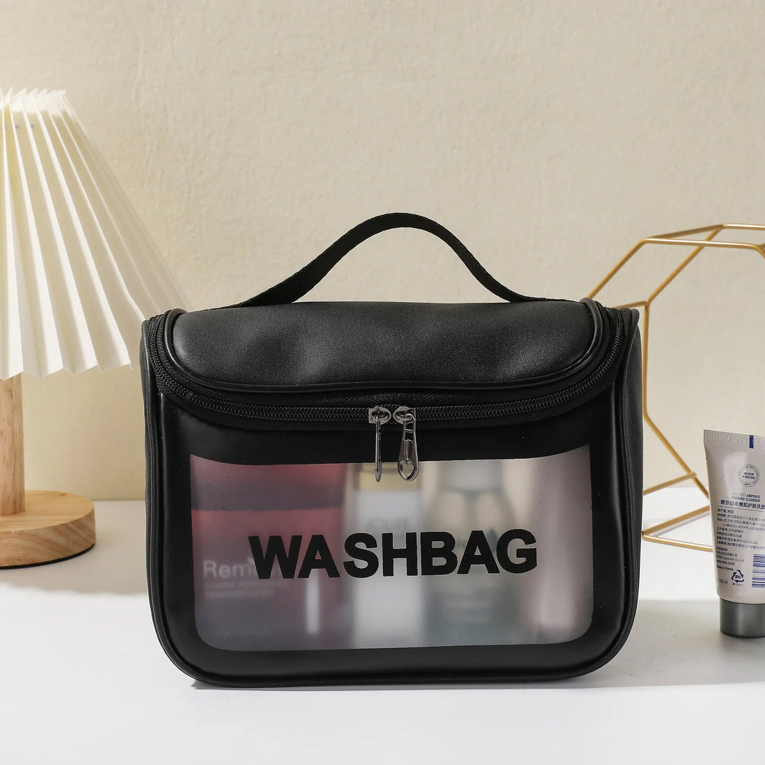 The black frosted washbag on a dressing table