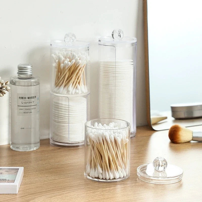 Cotton bud jars holding buds and cotton pads on a dressing table
