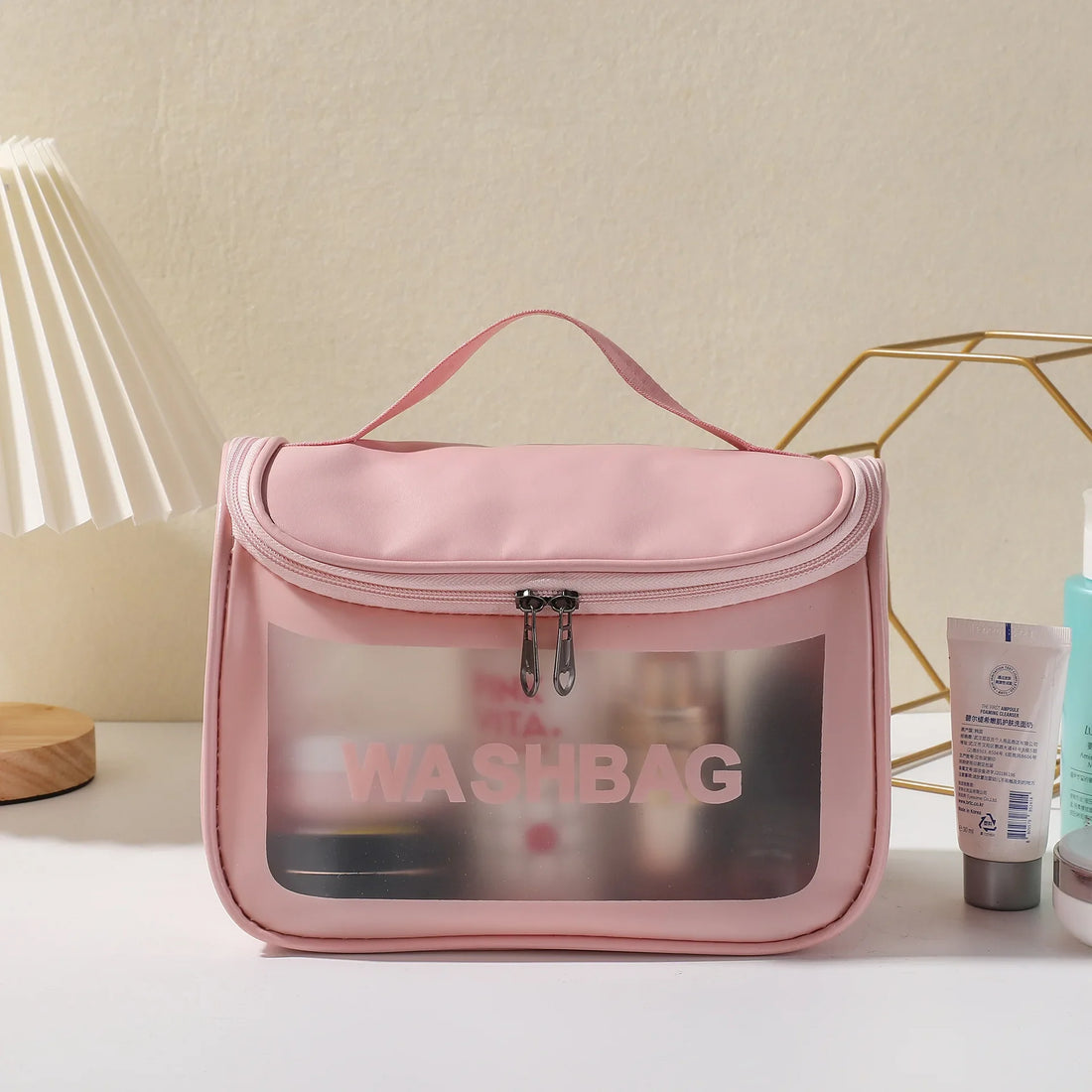 The pink frosted washbag on a dressing table