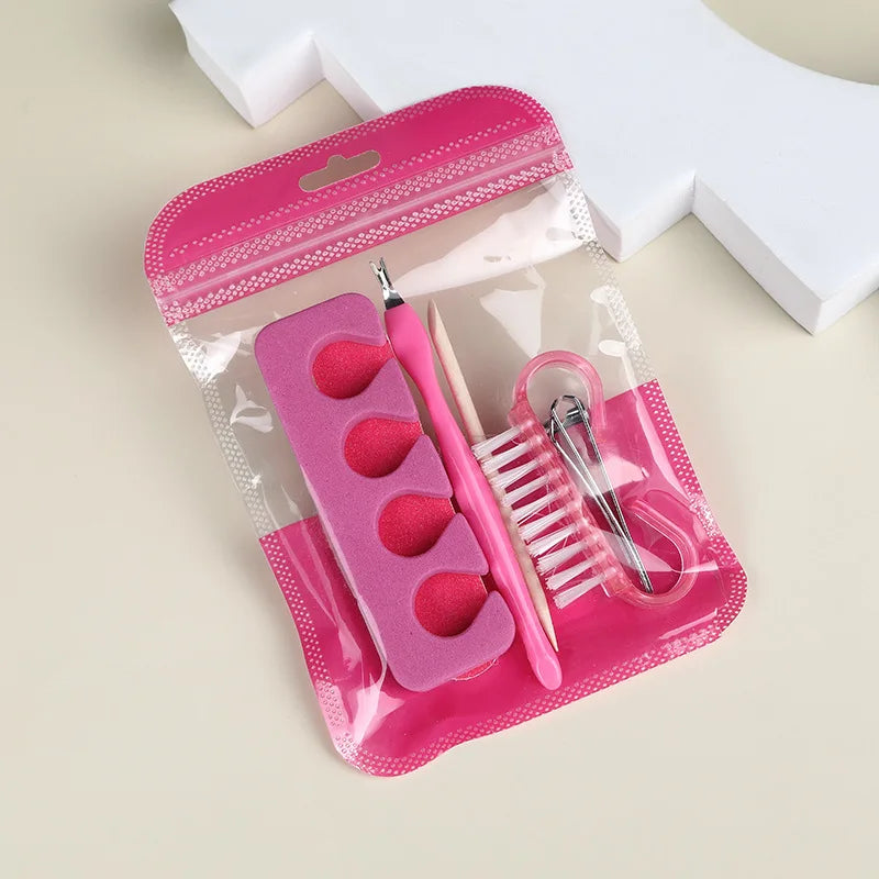 Pink pouch holding toe separators, a cuticle trimmer, a wooden stick, a nail brush and a nail clipper