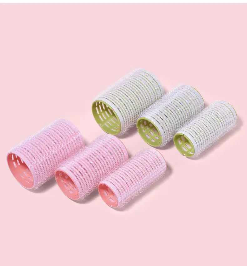 Six self-grip hair rollers in pink and green