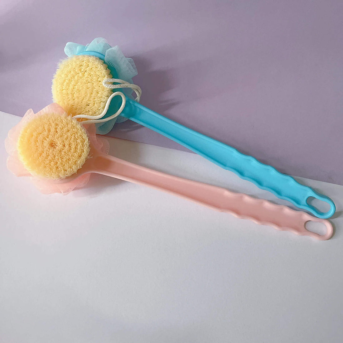 Two long-handled bath brushes with loofahs, in blue and pink