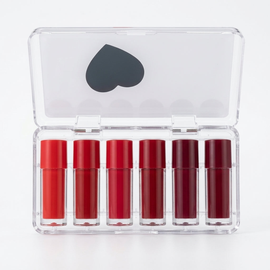 Six matte lip glosses in shades of red in a clear case with a mirror lid