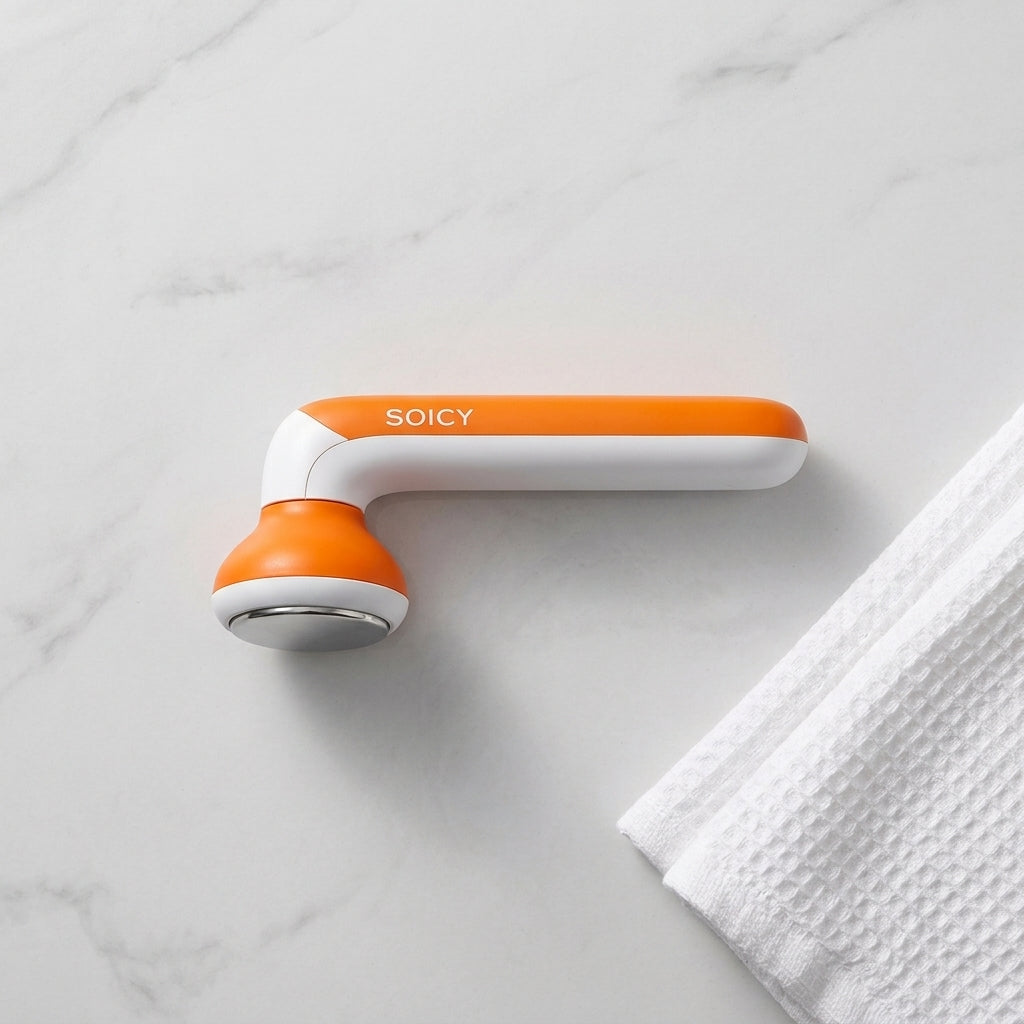 The cooling ice roller on a marble surface beside a towel