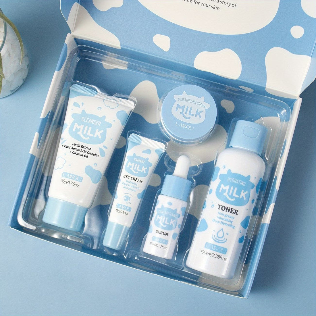 The open Milk box showing all five pieces: cleanser, toner, serum, eye cream and moisturising cream.