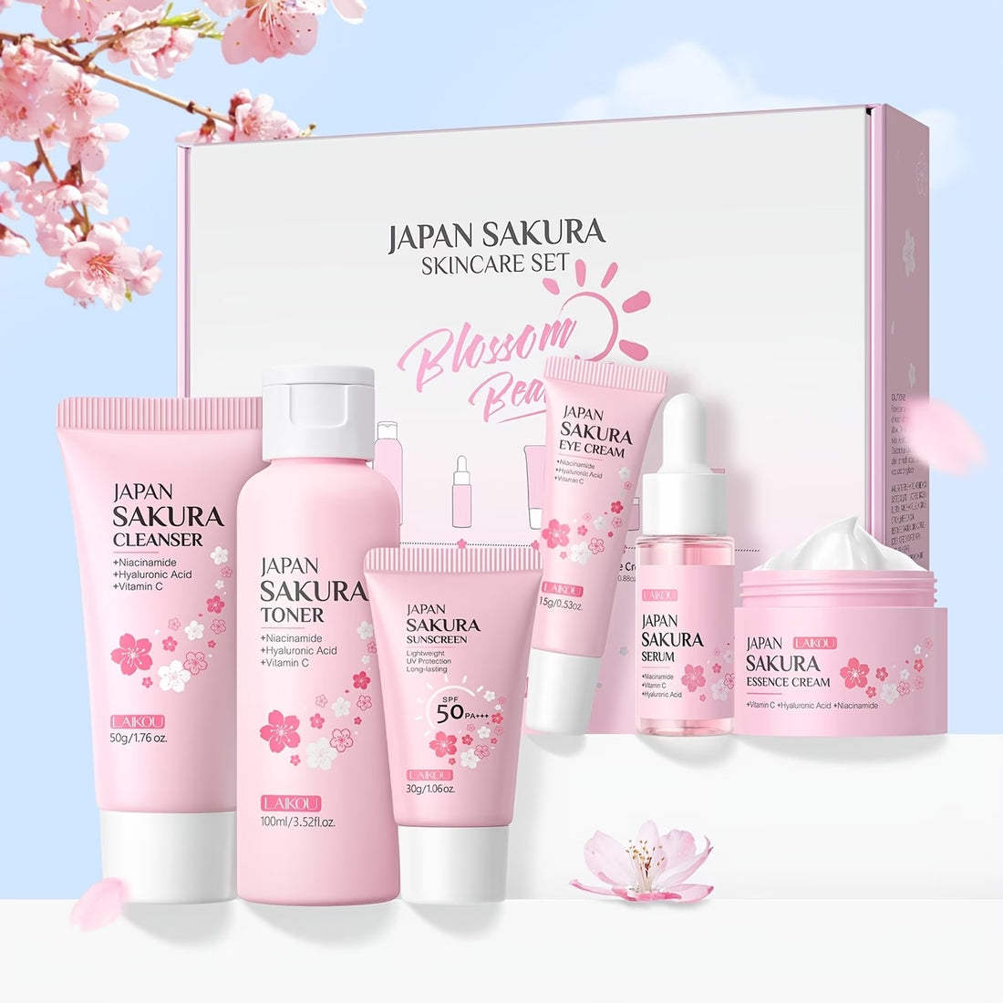 The Sakura six-piece set with its box, among cherry blossom against a pale sky.