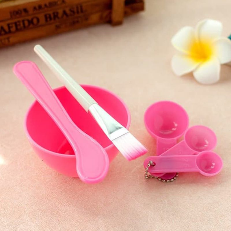 Pink mask bowl with a mixing stick, mask brush and three measuring spoons