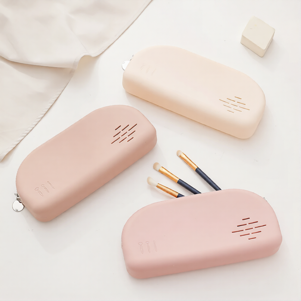 Pink and cream silicone makeup pouches with makeup brushes